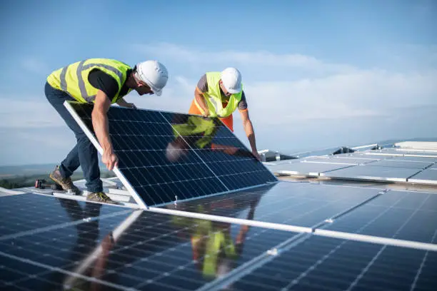 Certified technician installing solar panels on a rooftop
