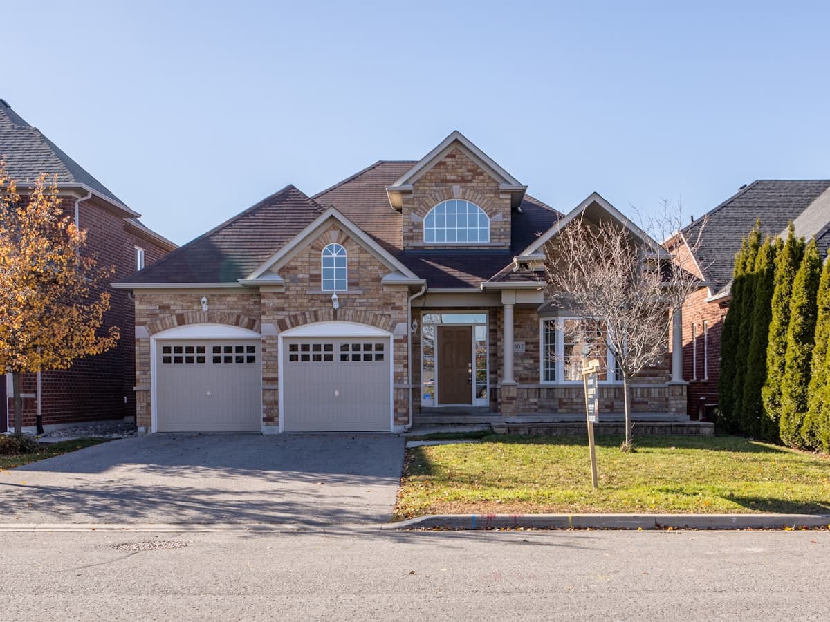 A classic suburban family house with a driveway and garage